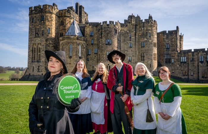 Alnwick Castle staff holding Green Tourism Award
