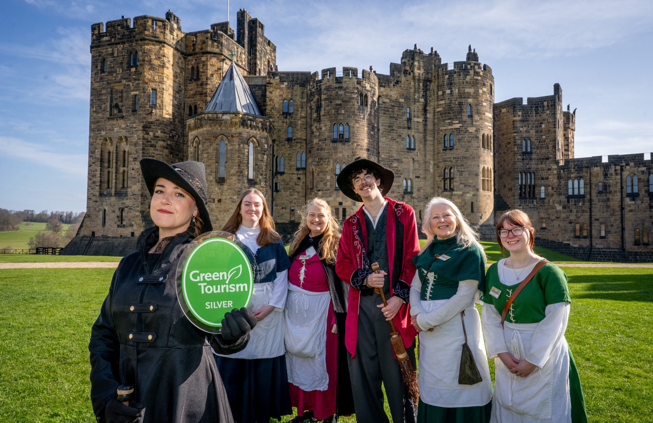 Alnwick Castle staff holding Green Tourism Award