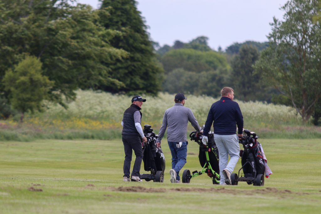 A team playing golf on the green